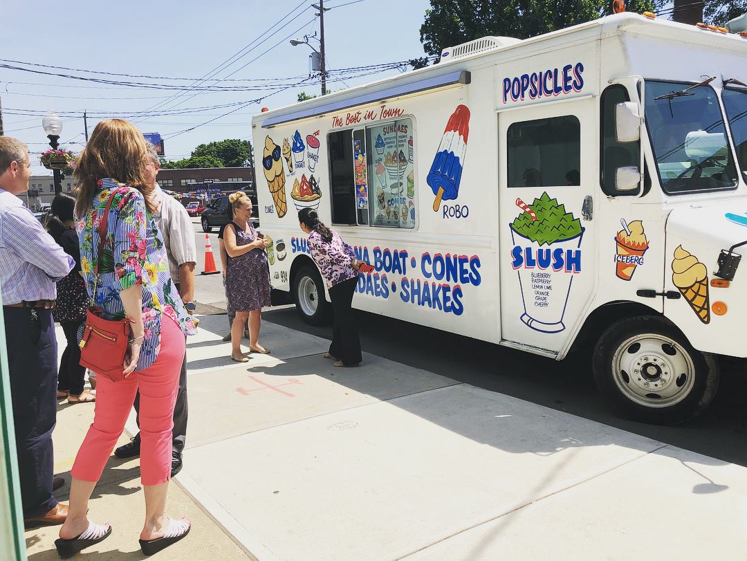 Caplan's employees outside in summer enjoying ice cream from an ice cream truck